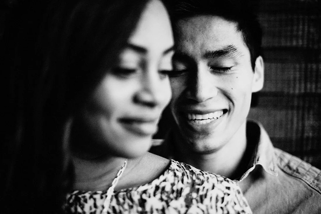 Black and white close-up of an engaged couple smiling