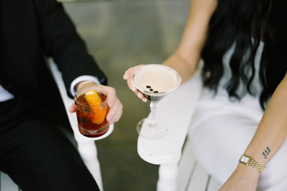 Engaged couple clinking an old fashioned and an espresso martini at Congress Hall in Cape May, NJ