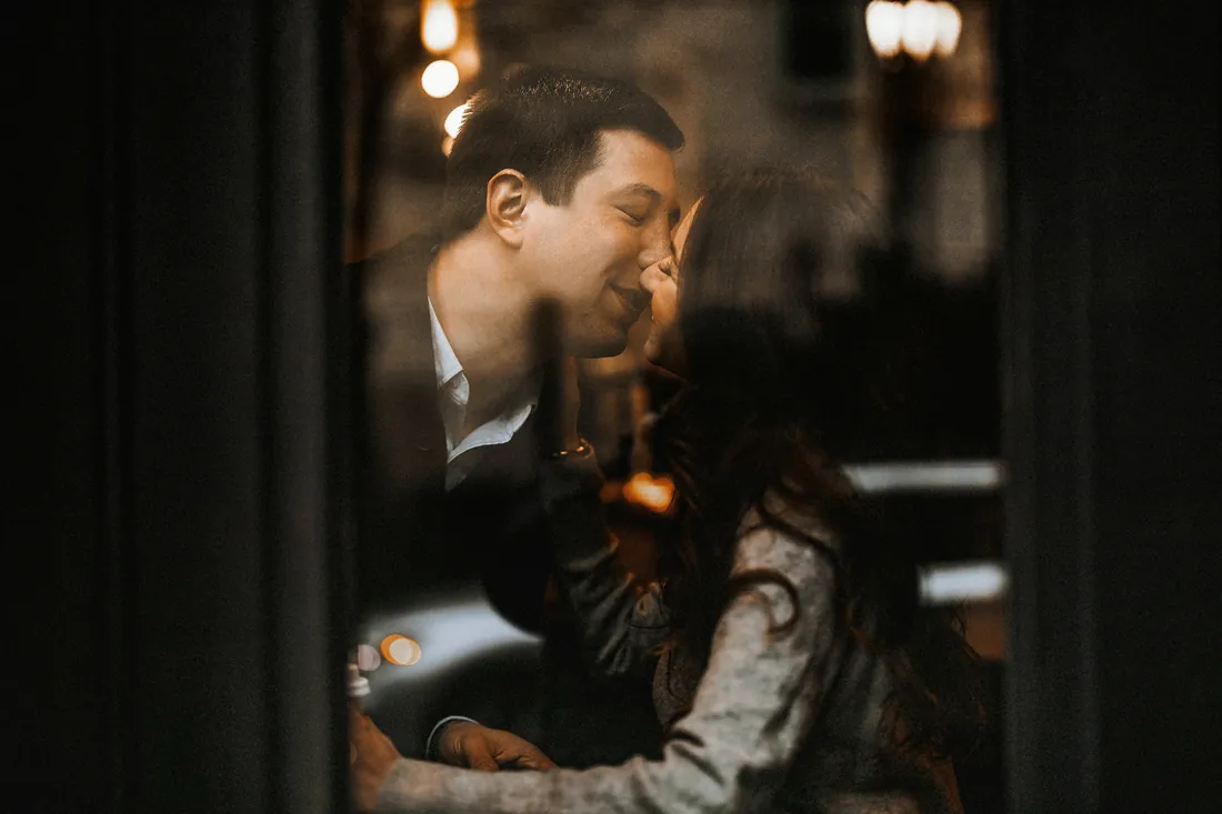 Engaged couple sharing a quiet moment by candlelight