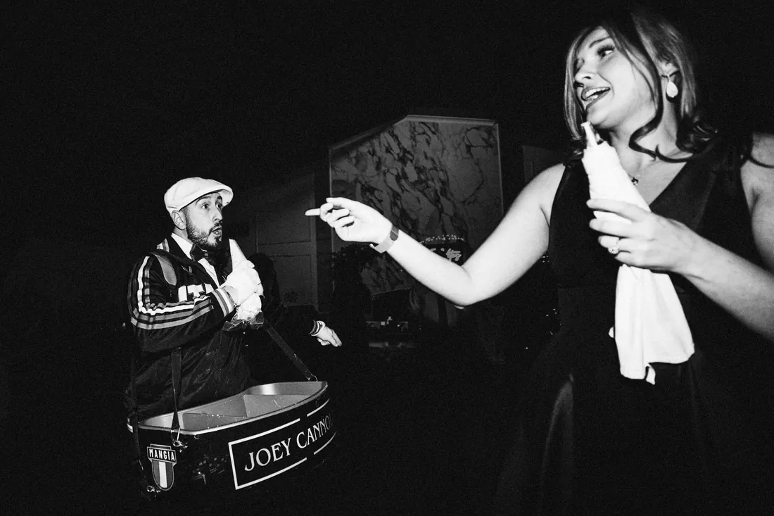 Black and white photo of a guest dancing to a steel drum