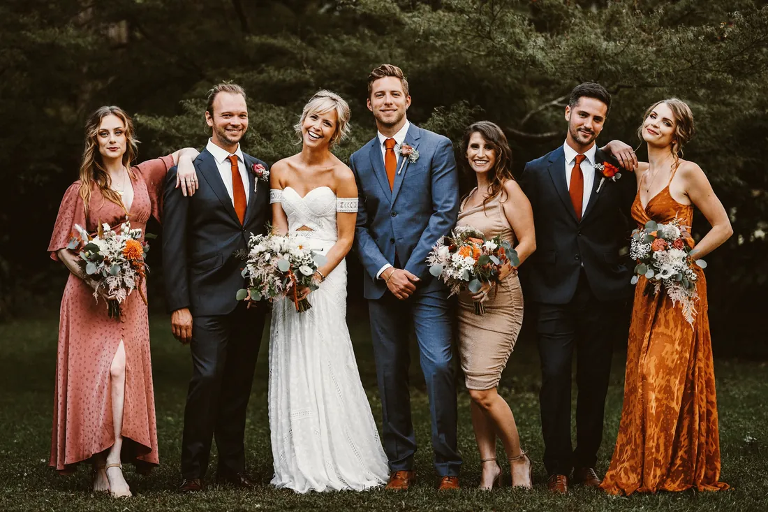 Bride and groom with their bridal party in rust and blush colors