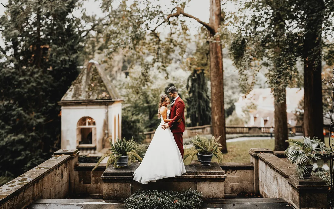 Bride and groom embracing in a stone garden