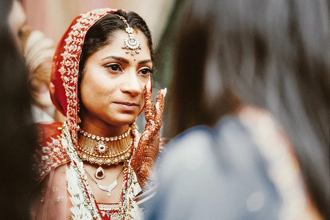Close-up of a bride in red with traditional jewelry