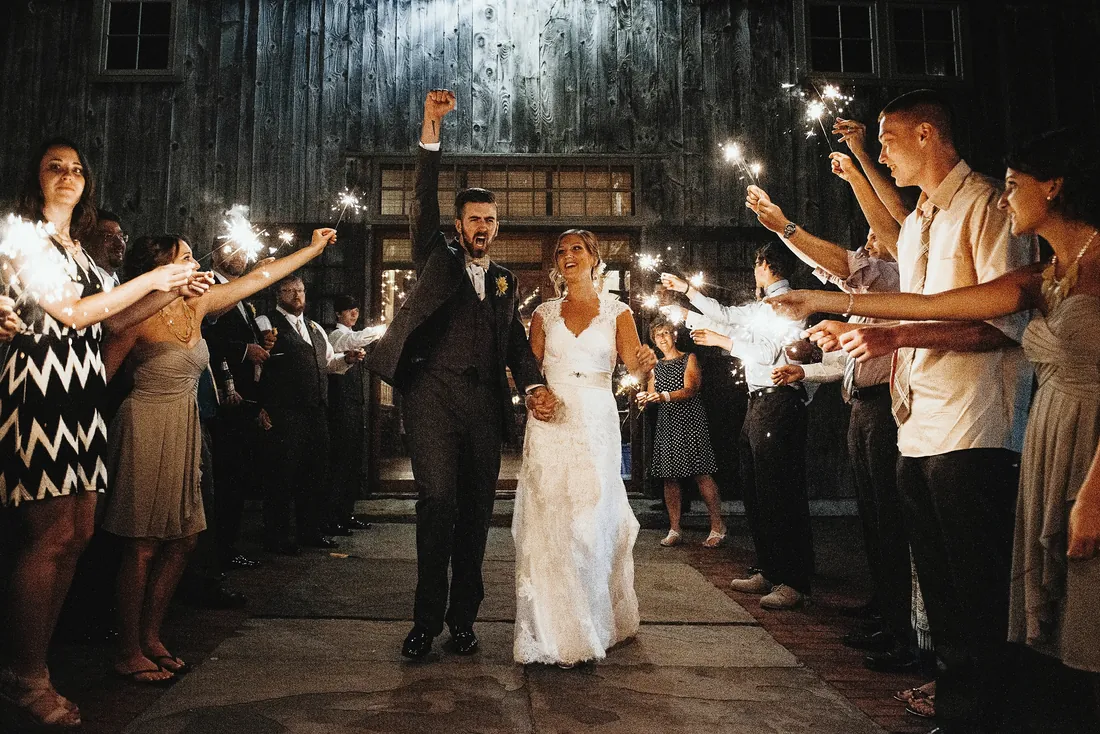 Bride and groom celebrating during their sparkler exit