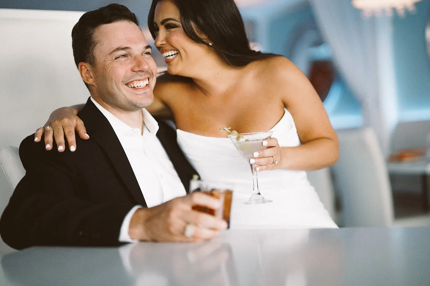Branon and Celeste laughing together over cocktails