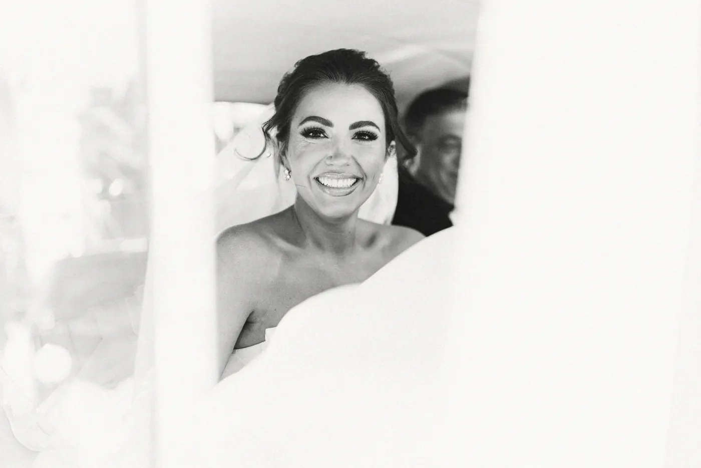 Black and white photo of Celeste smiling from the car