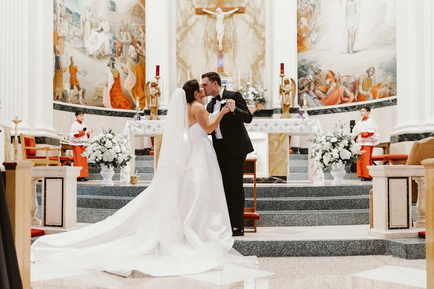 Branon and Celeste's first kiss at the altar during their ceremony at Saint Monica Roman Catholic Church in South Philadelphia