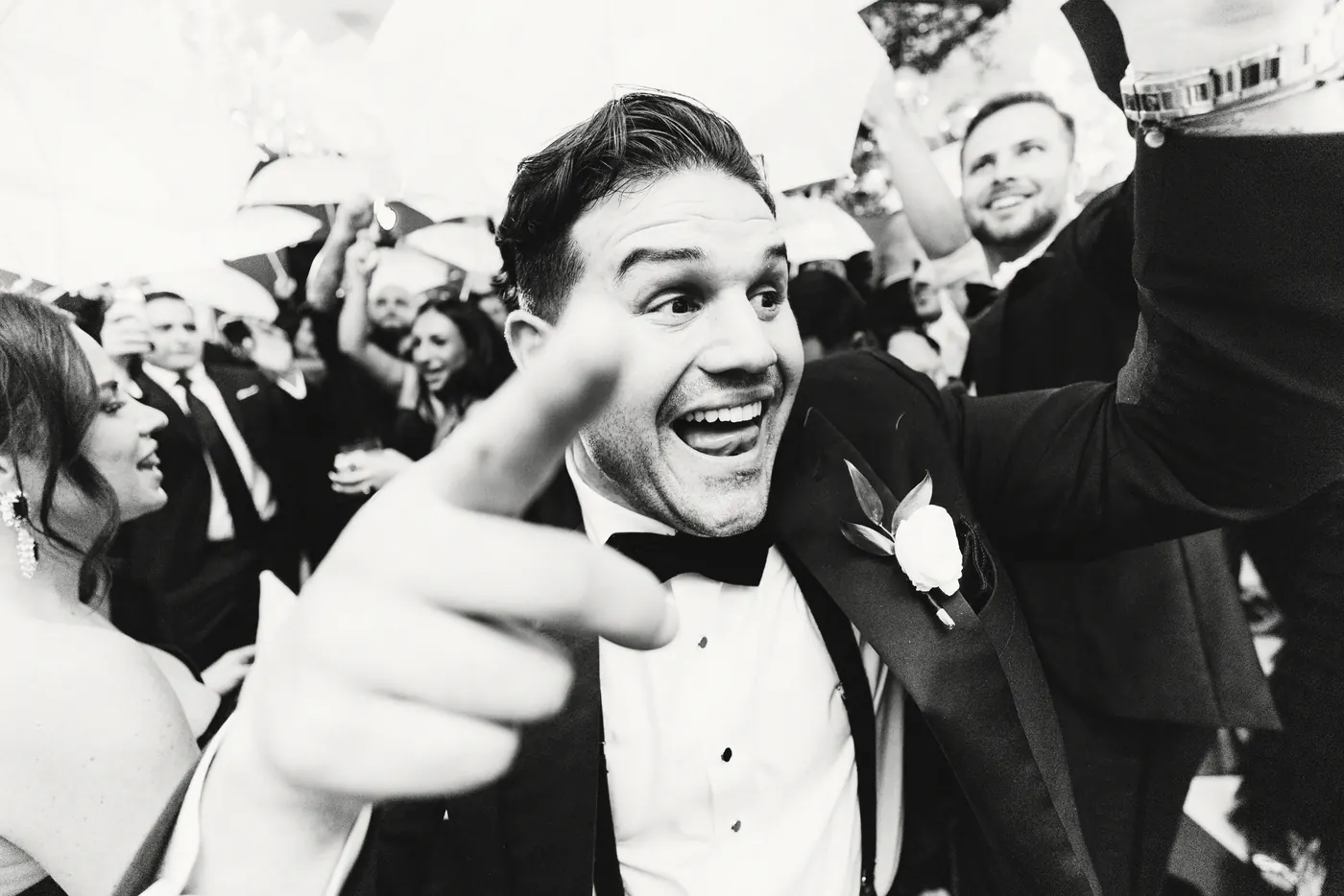 Black and white photo of a guest pointing and laughing on the dance floor at The Vie by Cescaphe in Philadelphia
