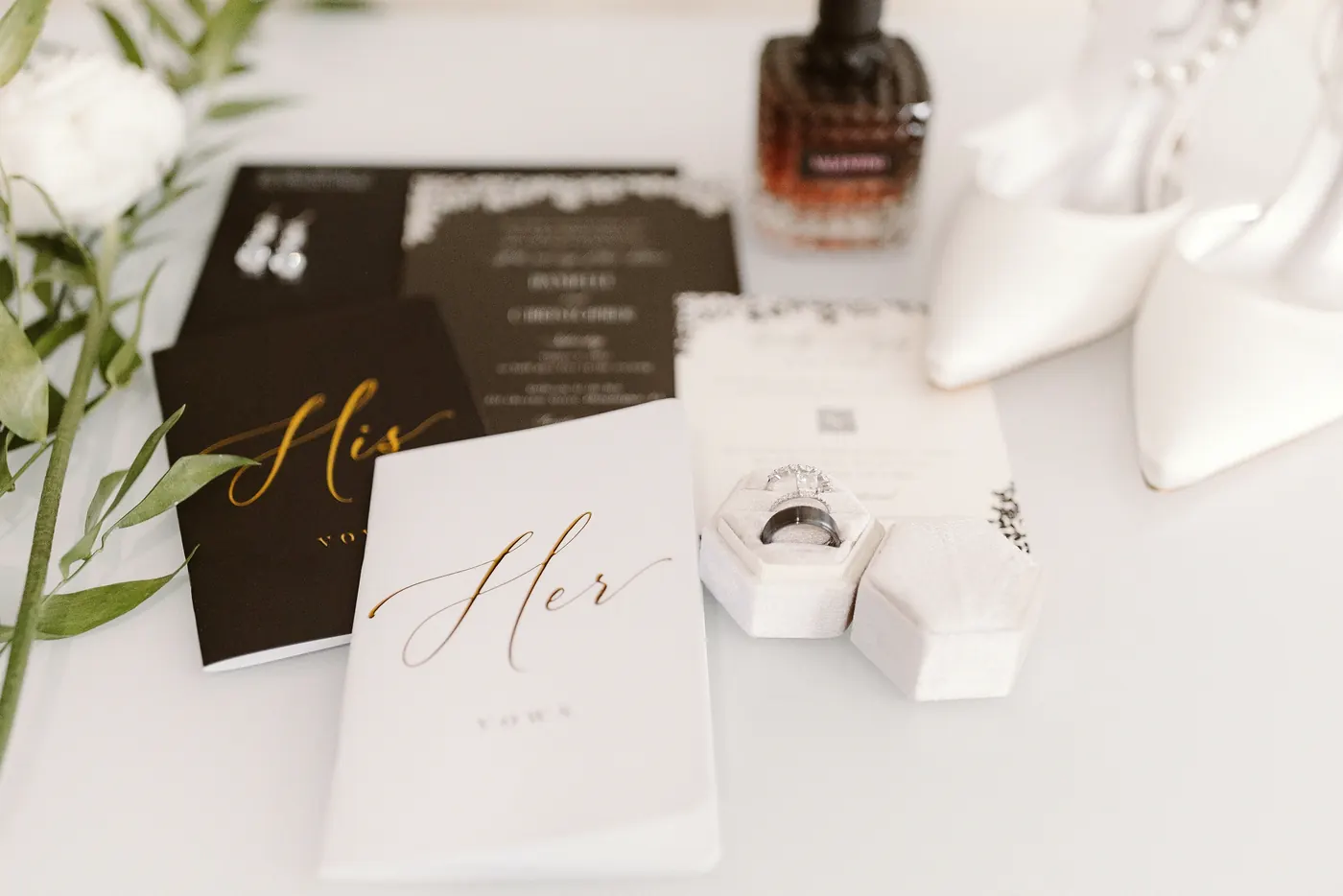 His and her vow books, rings, perfume and bridal shoes