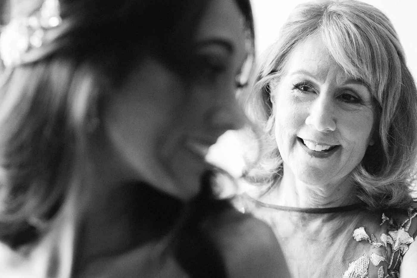 Black and white photo of Danielle's mom smiling at her as she gets ready