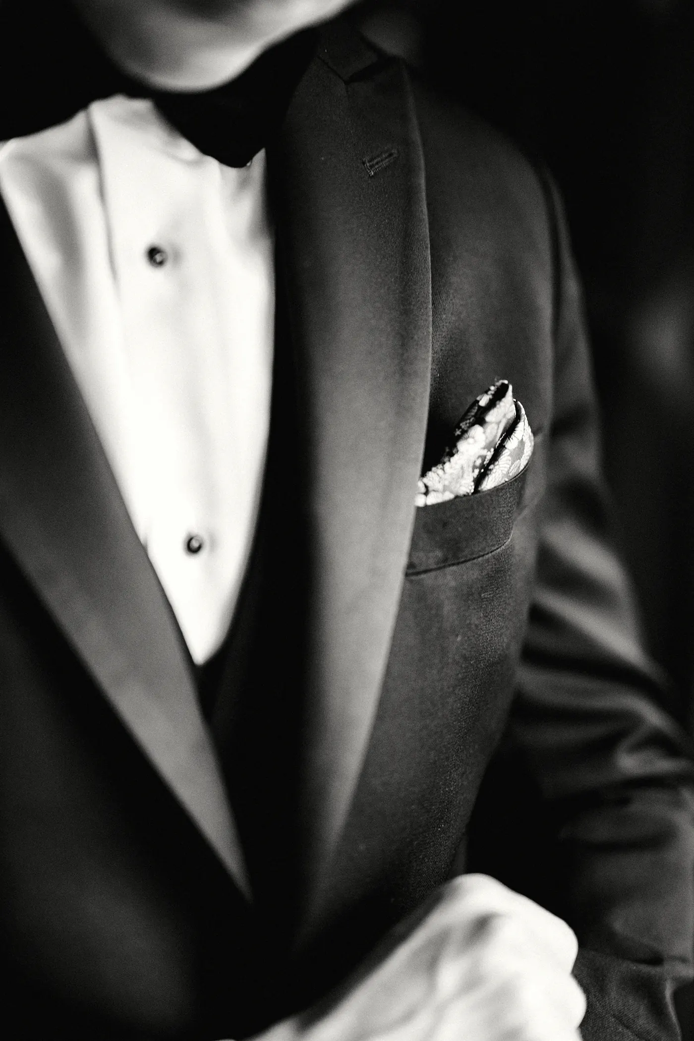 Black and white close-up of Chris's tuxedo and pocket square