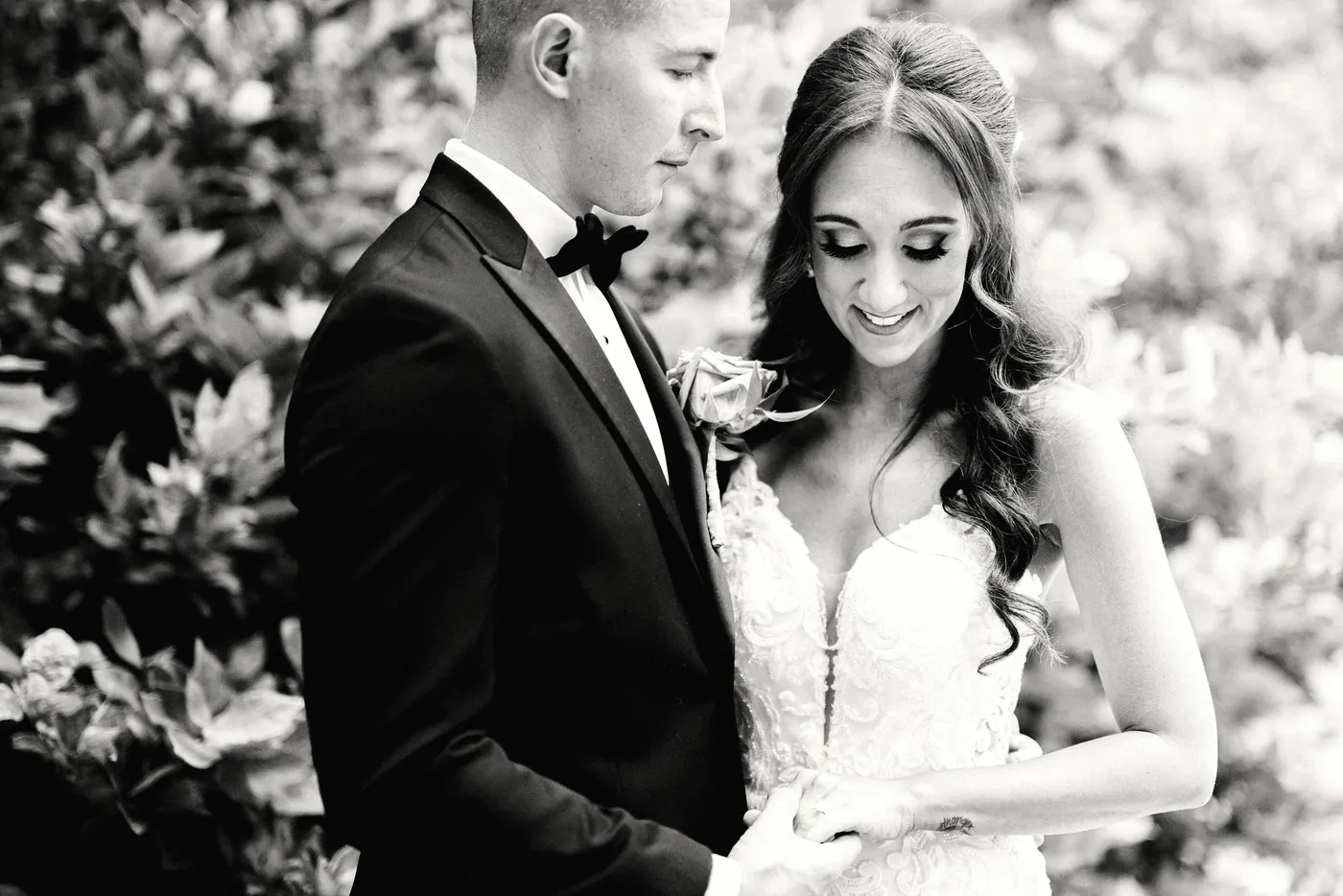 Black and white photo of Danielle smiling down as Chris holds her hands at the Rodin Museum in Philadelphia