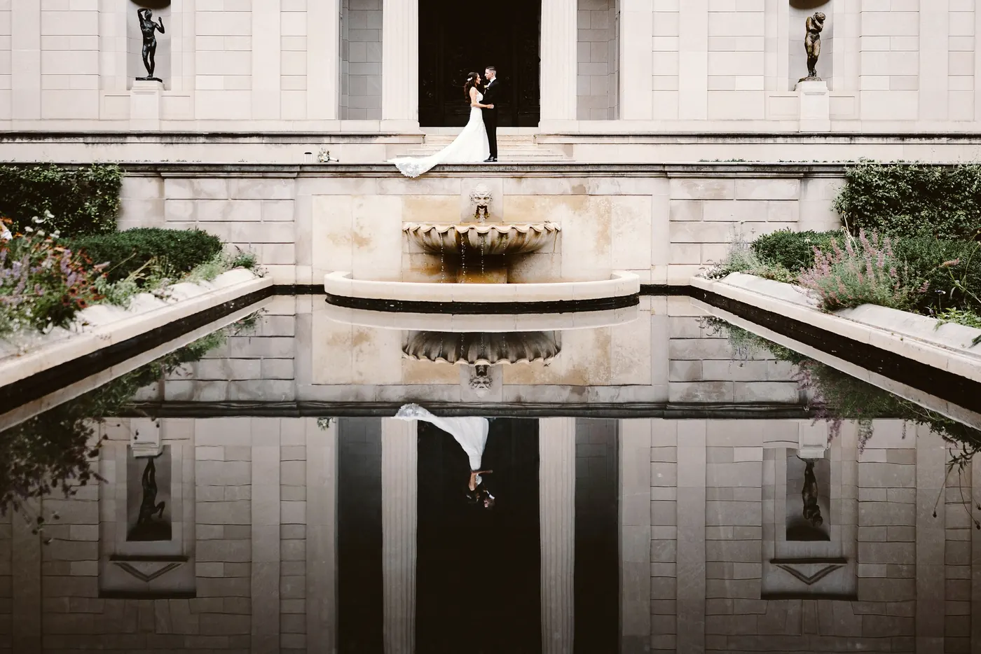 Chris and Danielle reflected in the long pool in front of the museum at the Rodin Museum in Philadelphia