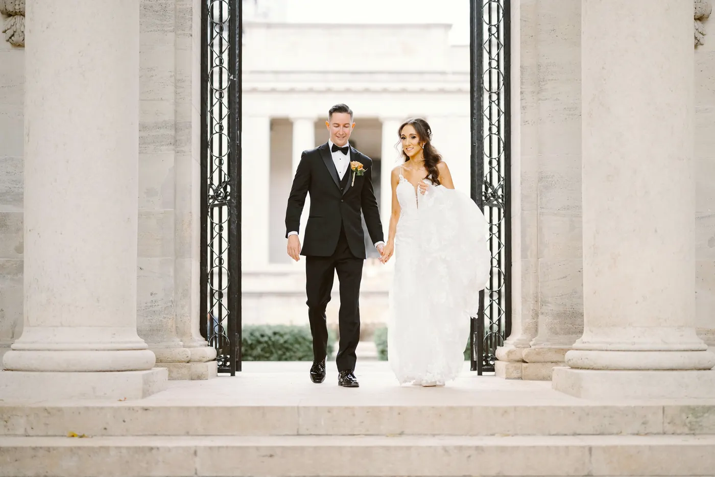 Chris and Danielle walking out between the columns and iron gates at the Rodin Museum in Philadelphia