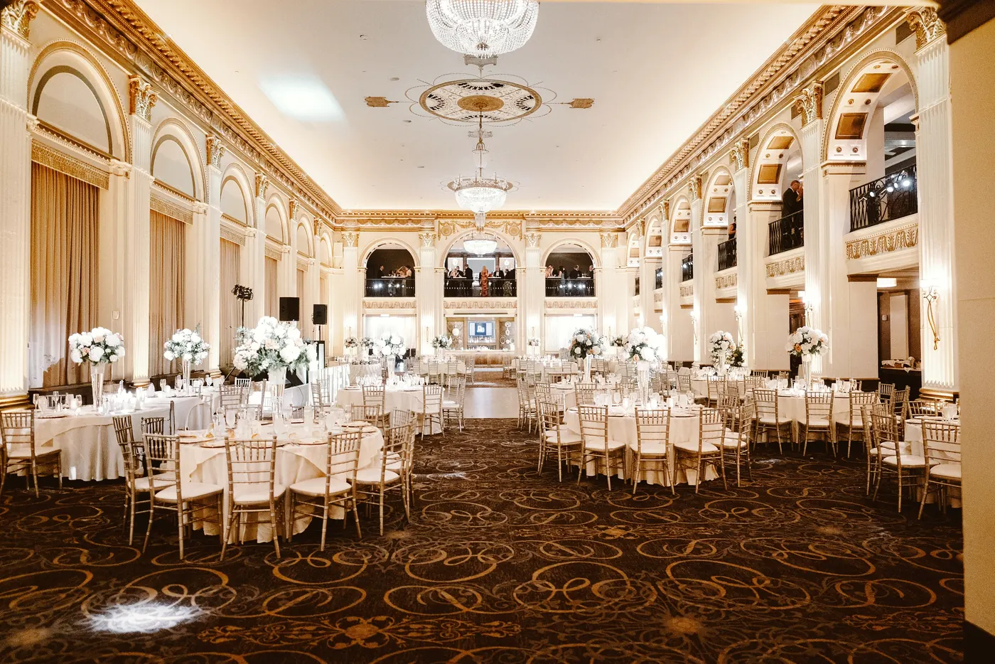 The gold and cream ballroom set for the reception at Cescaphe Ballroom at the Ben in Philadelphia