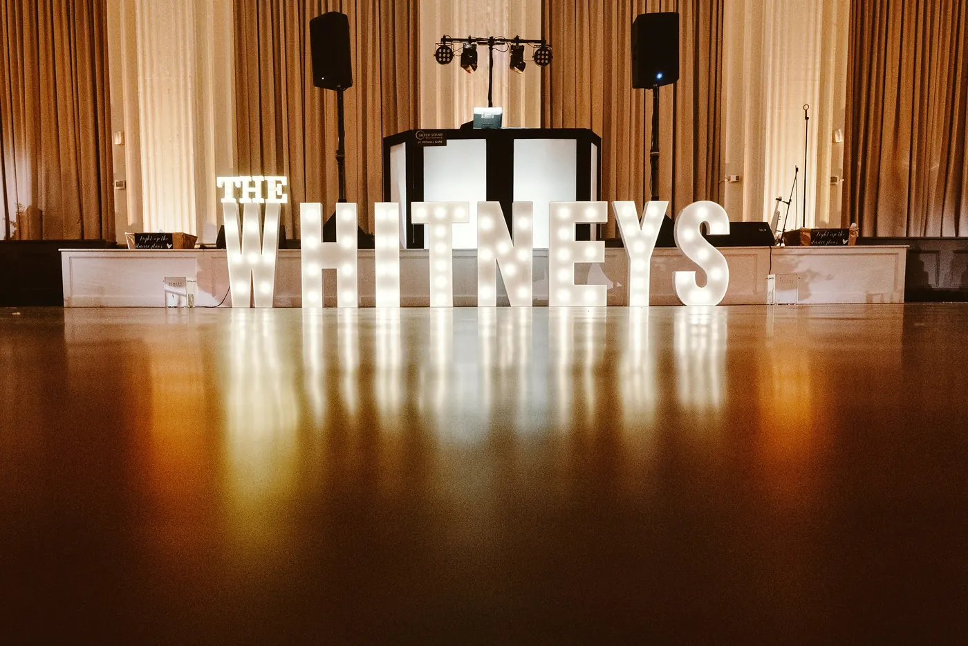 Light-up letters spelling The Whitneys on the dance floor at Cescaphe Ballroom at the Ben in Philadelphia