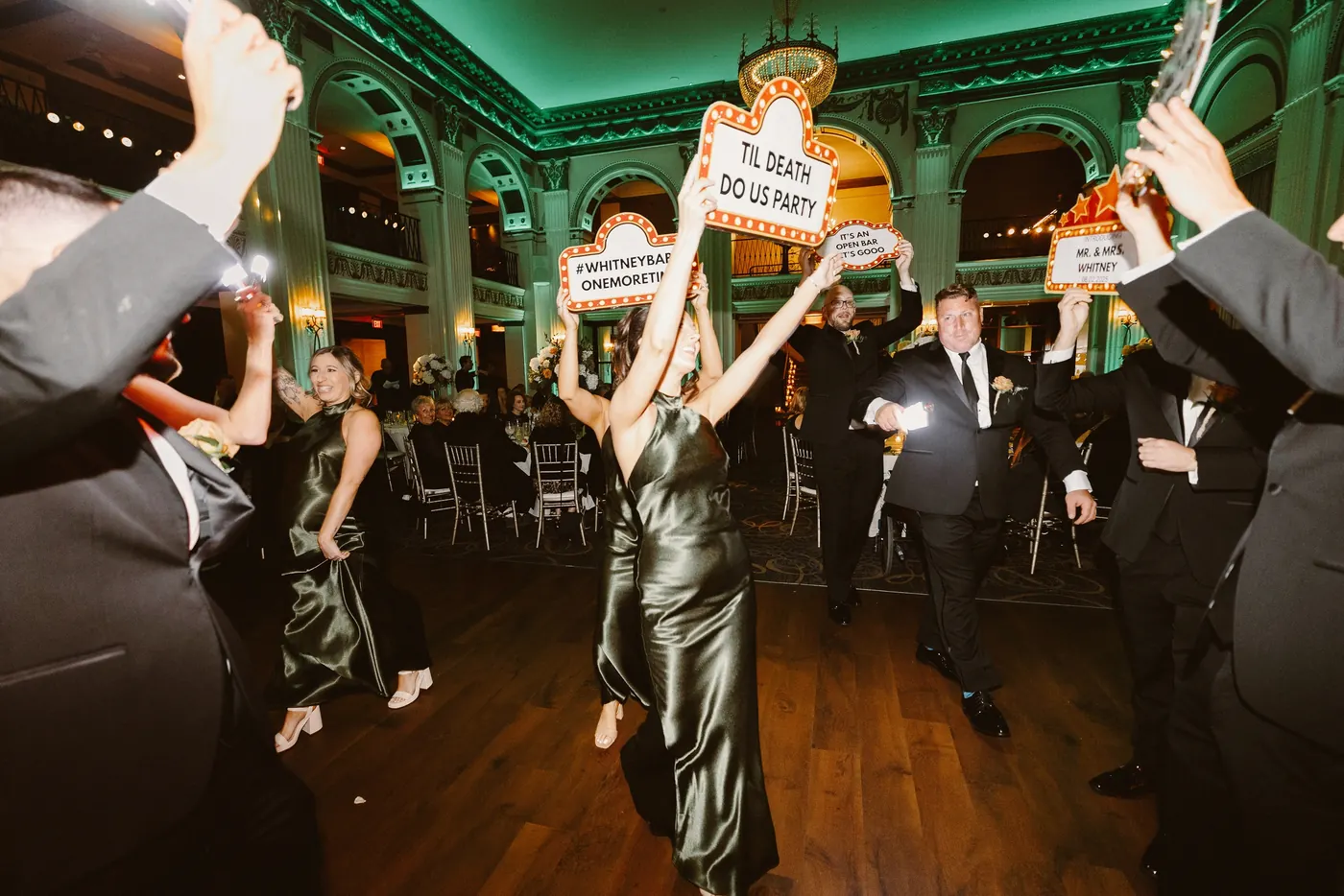 Guests cheering as the wedding party makes their grand entrance at Cescaphe Ballroom at the Ben in Philadelphia