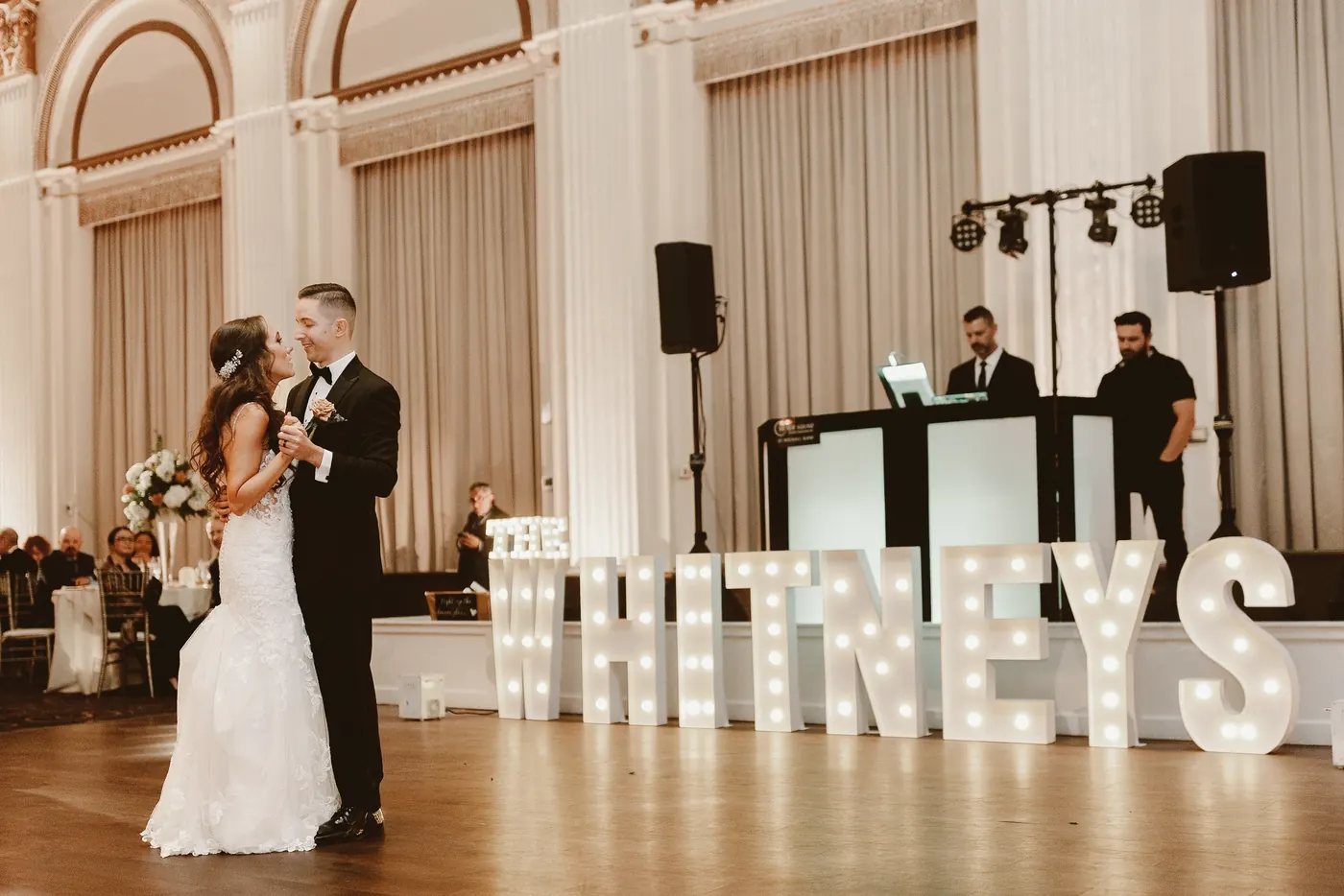Chris and Danielle's first dance in front of the light-up sign at Cescaphe Ballroom at the Ben in Philadelphia