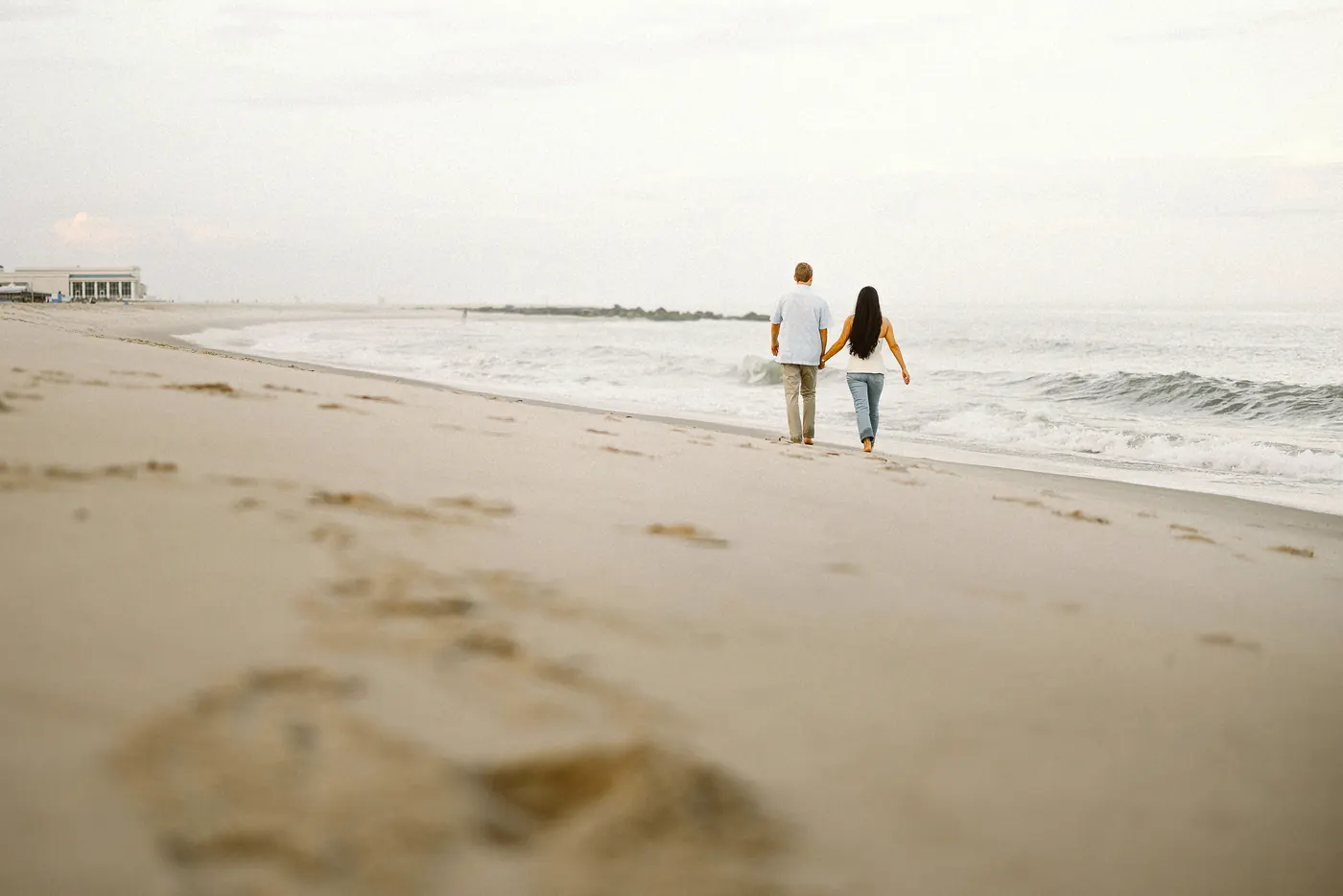 Mason and Morgan walking along the shoreline in Cape May, NJ, near Congress Hall