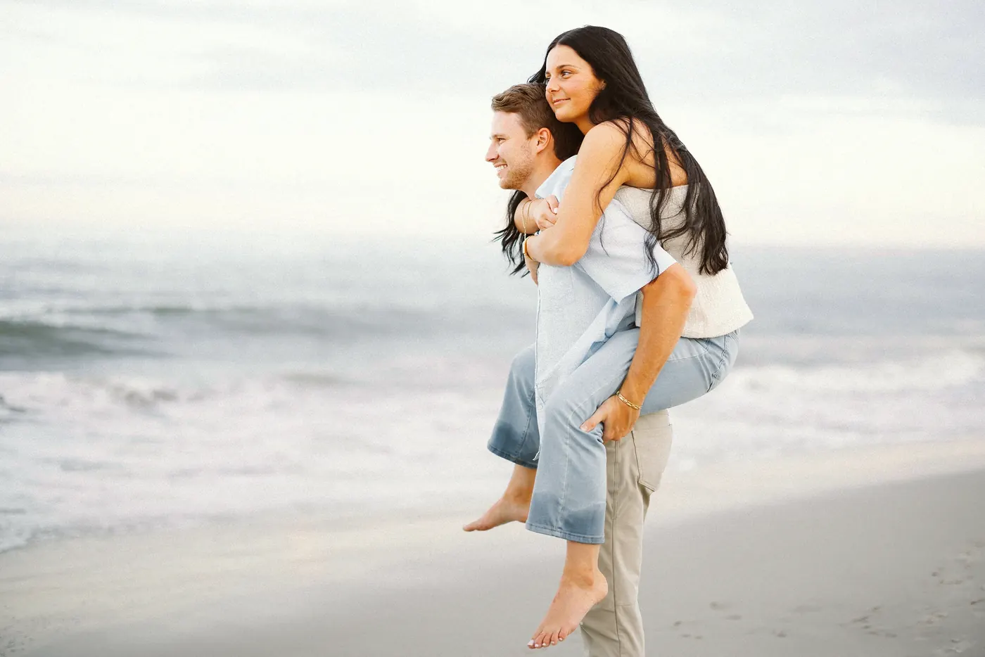 Mason giving Morgan a piggyback ride by the water