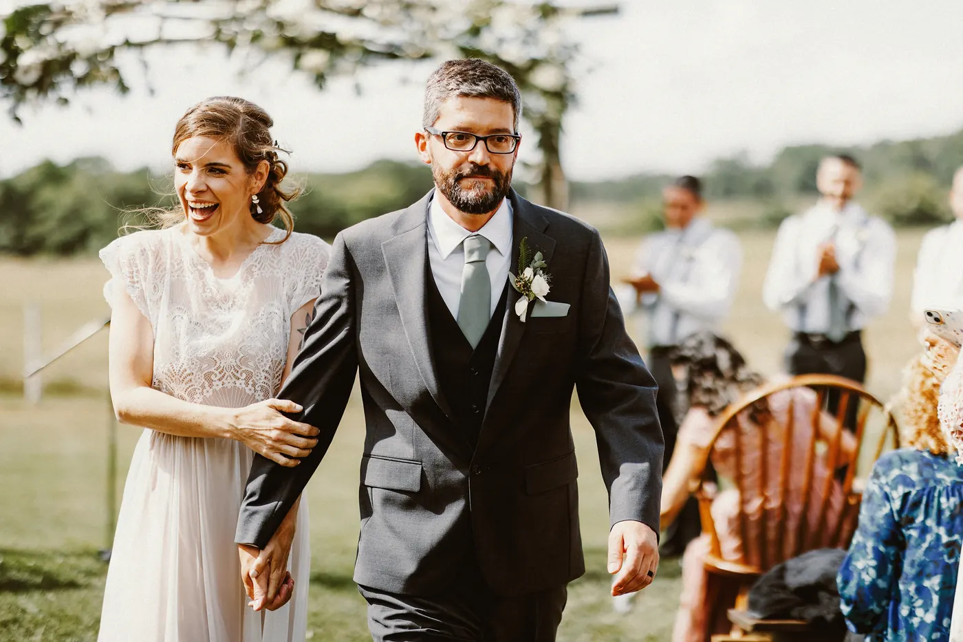 Erica laughing as she and Matt walk back up the aisle after the ceremony at Johnson's Locust Hall Farm in Jobstown, NJ