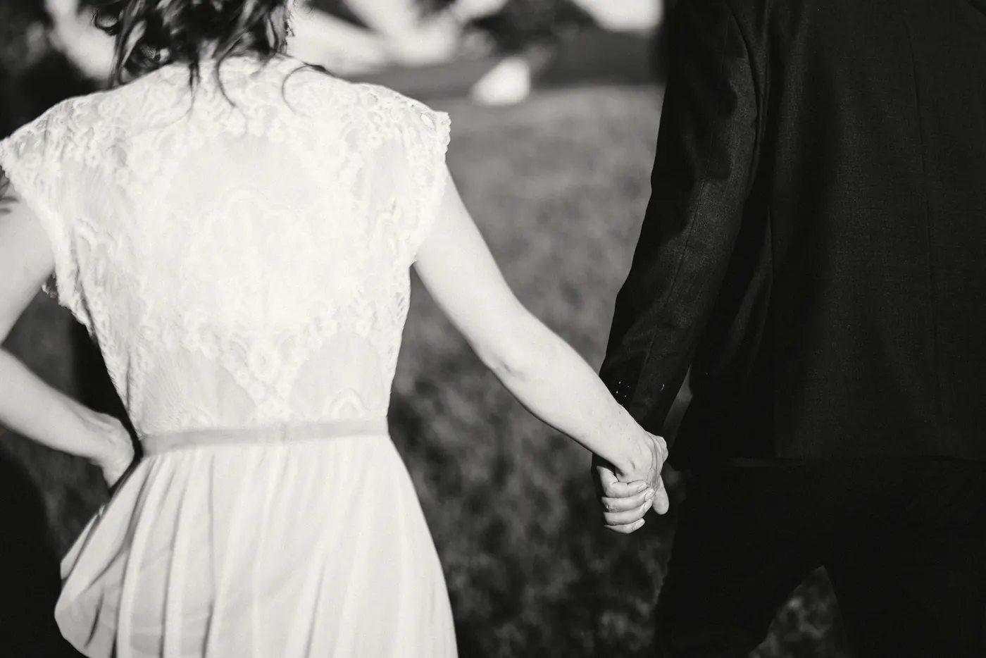 Black and white close-up of Erica leading Matt by the hand at Johnson's Locust Hall Farm in Jobstown, NJ