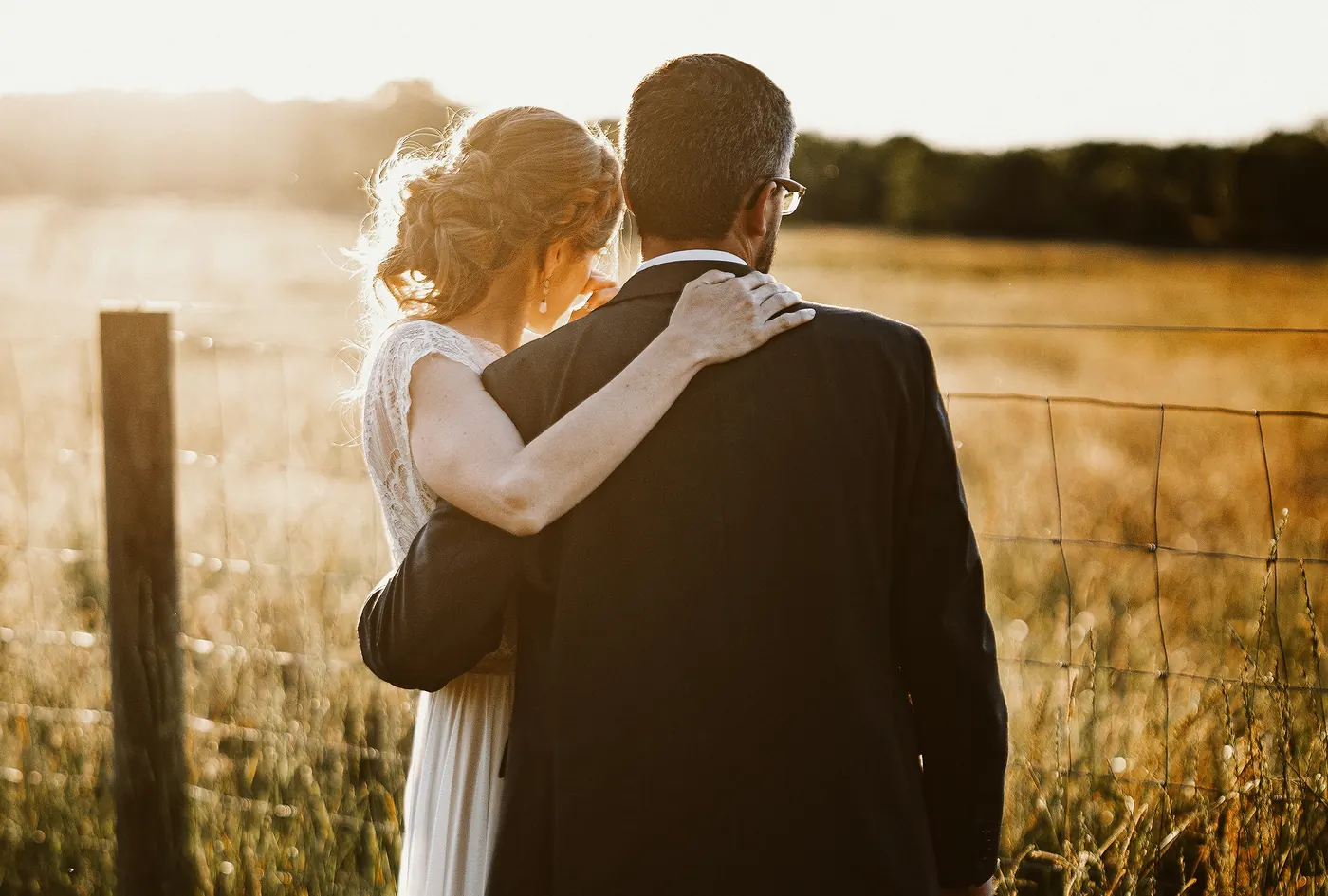 Erica wrapping her arm around Matt in the golden hour light at Johnson's Locust Hall Farm in Jobstown, NJ