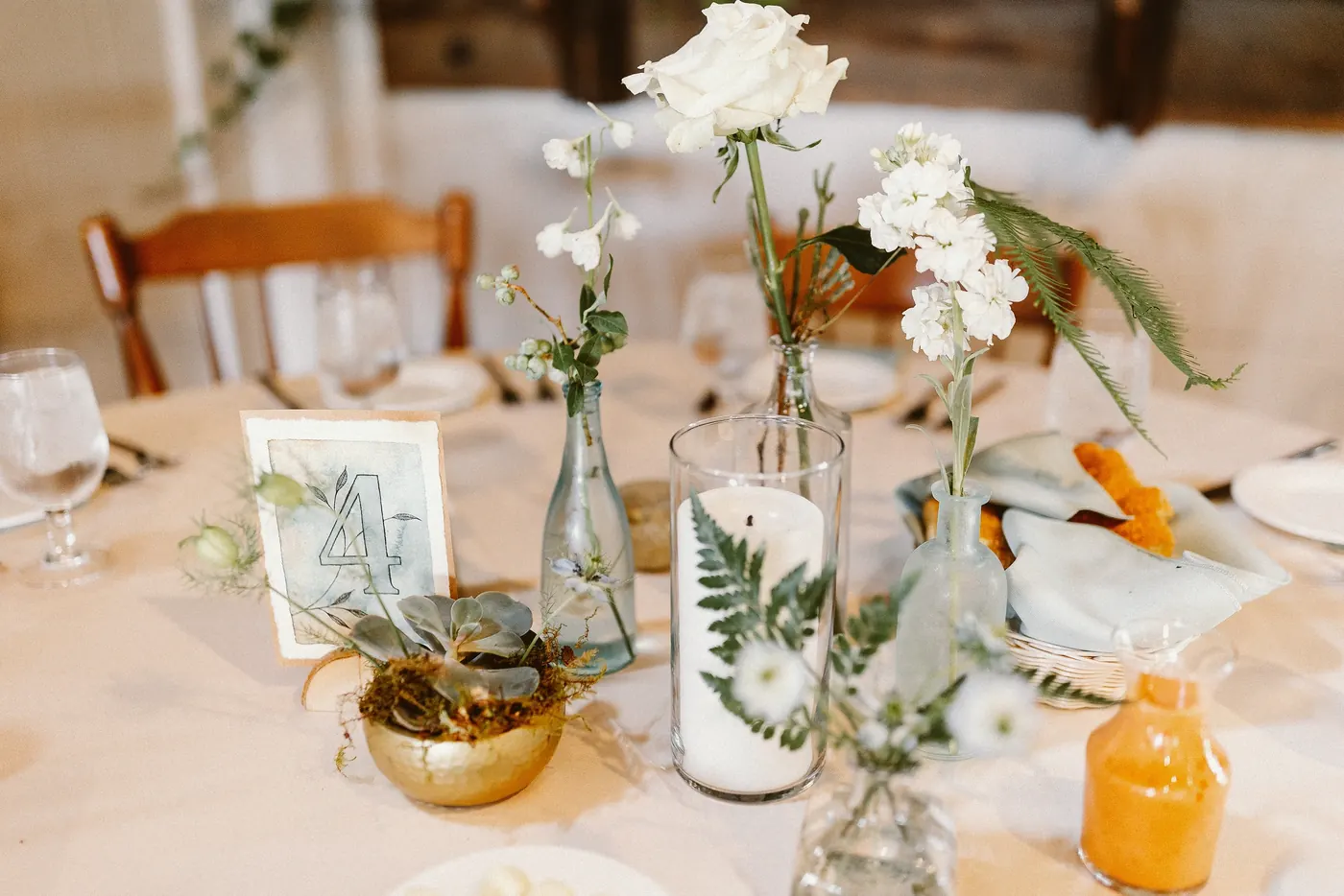 A table number with candles, succulents and white flowers at Johnson's Locust Hall Farm in Jobstown, NJ
