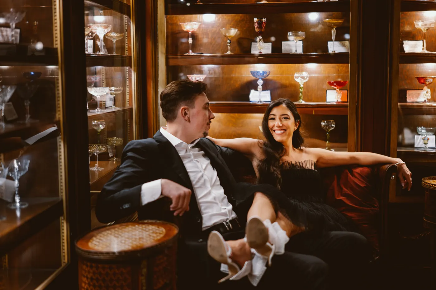 Morgan with her legs across Will's lap in the vintage tasting room at Renault Winery in Egg Harbor City, NJ