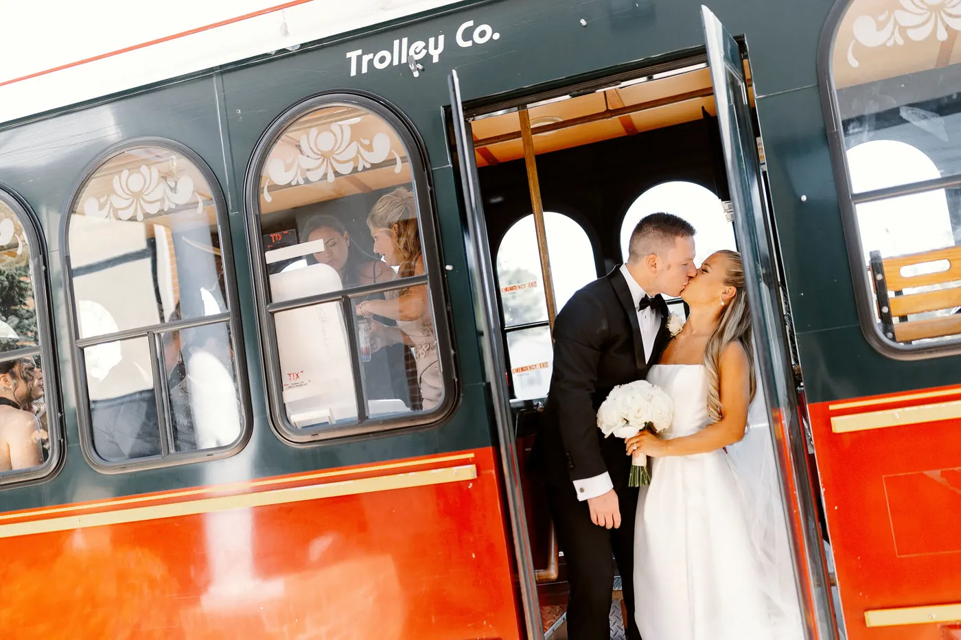Steve and Madison kissing in the doorway of a red trolley