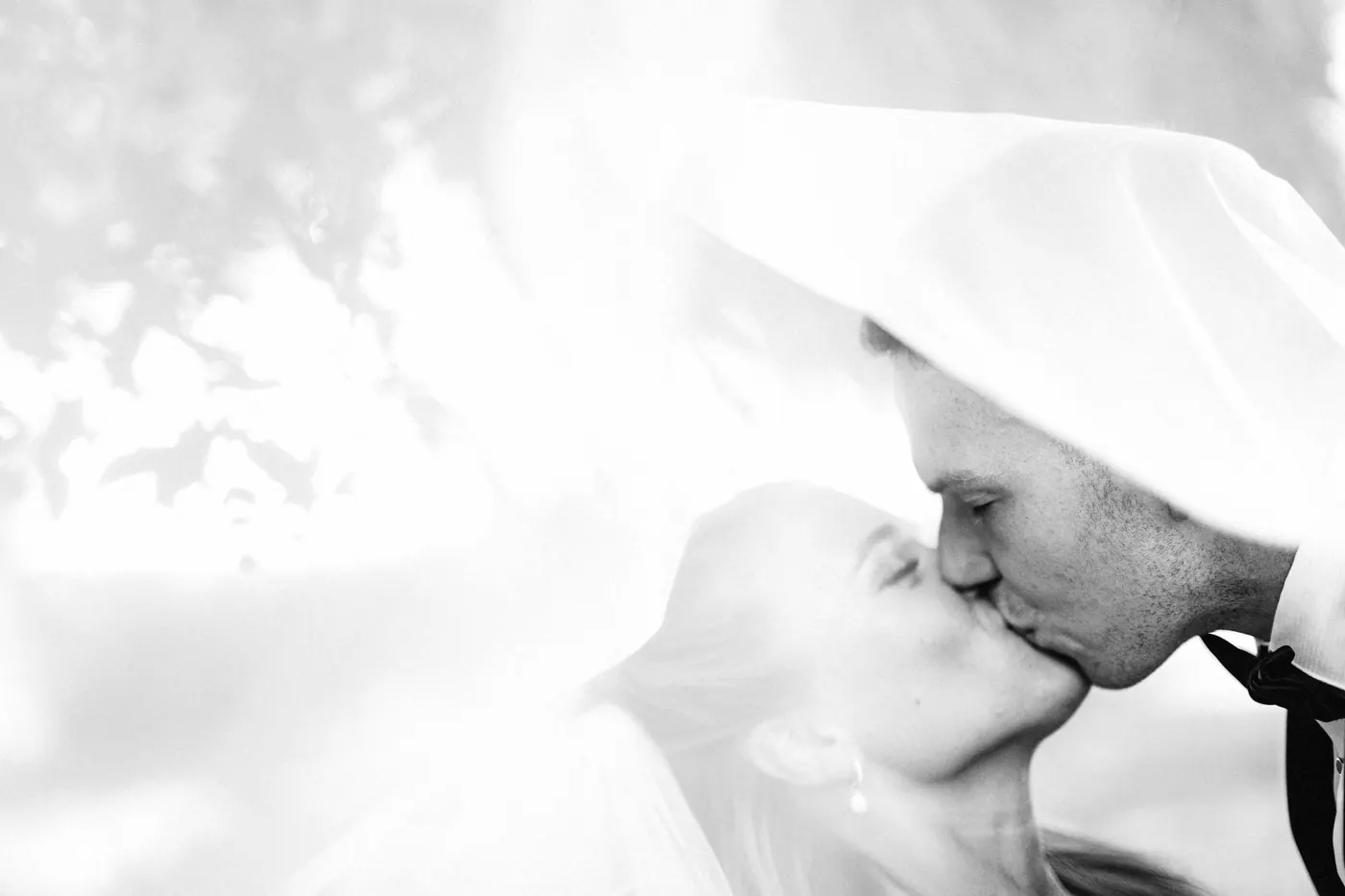 A soft, sunlit kiss beneath Madison's veil