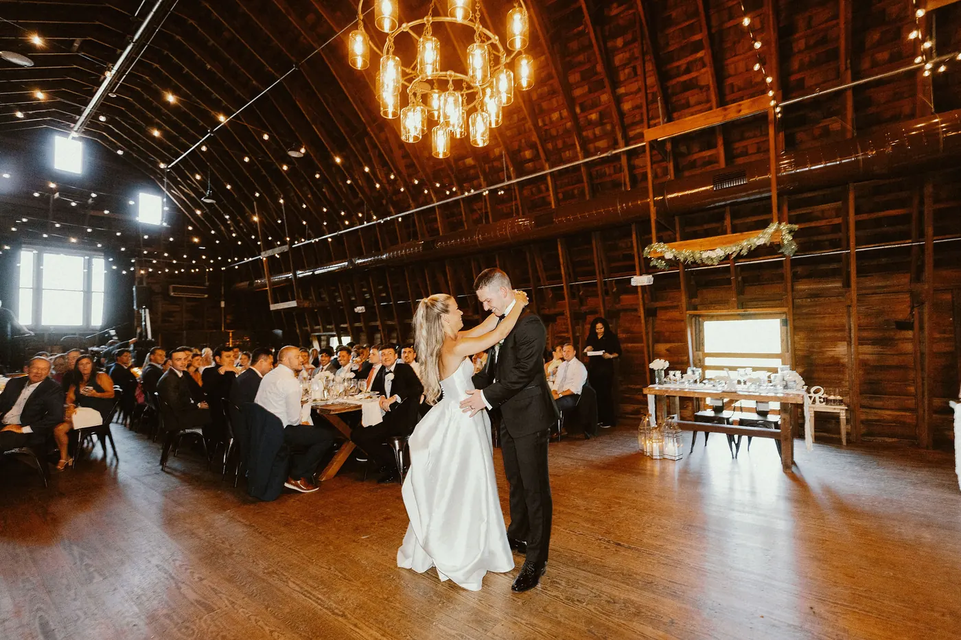 Steve and Madison's first dance under the barn's chandeliers
