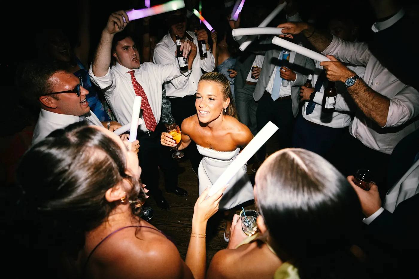 Madison dancing with friends as guests wave light sticks