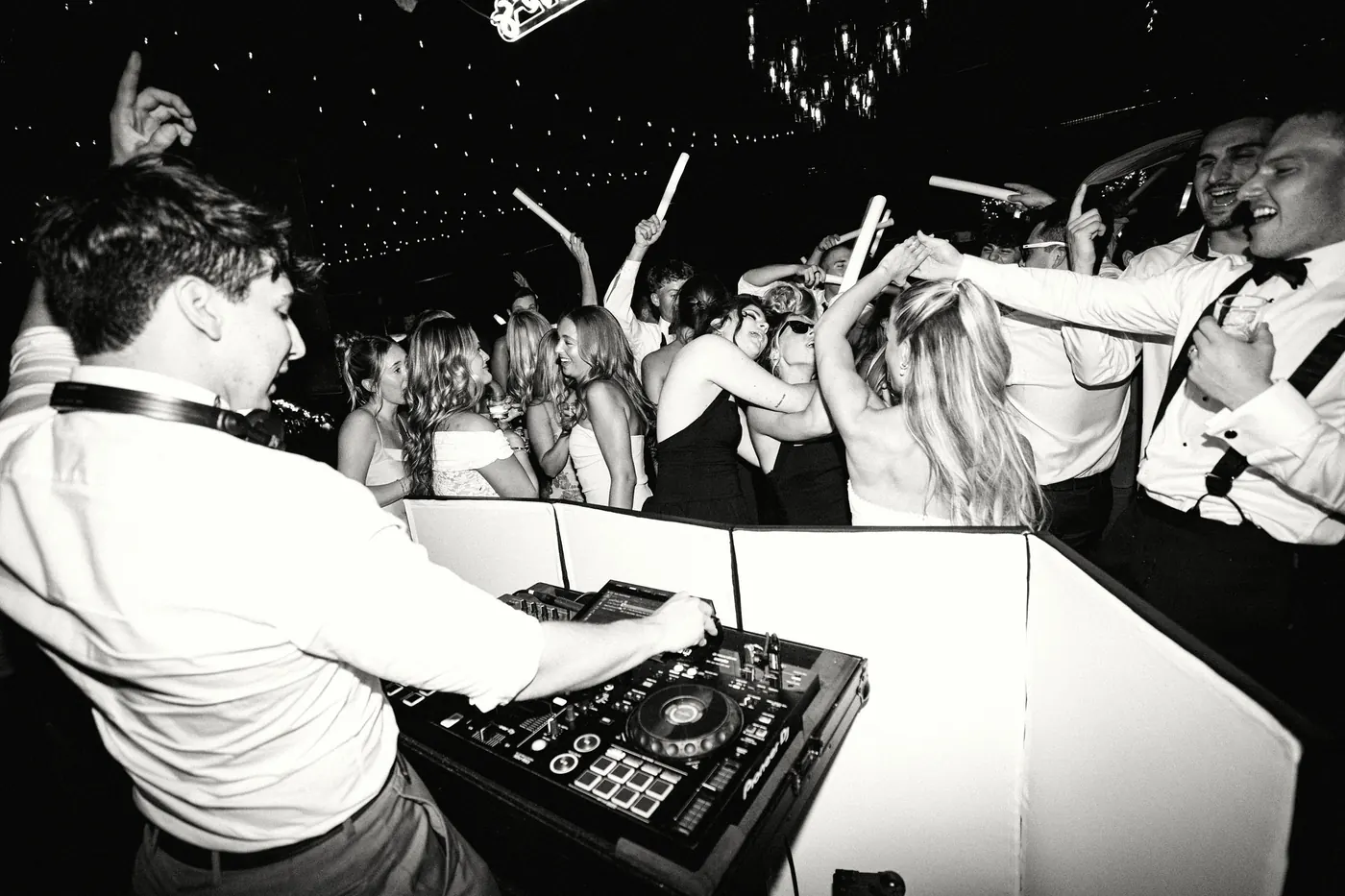 The DJ booth and a crowded dance floor, in black and white