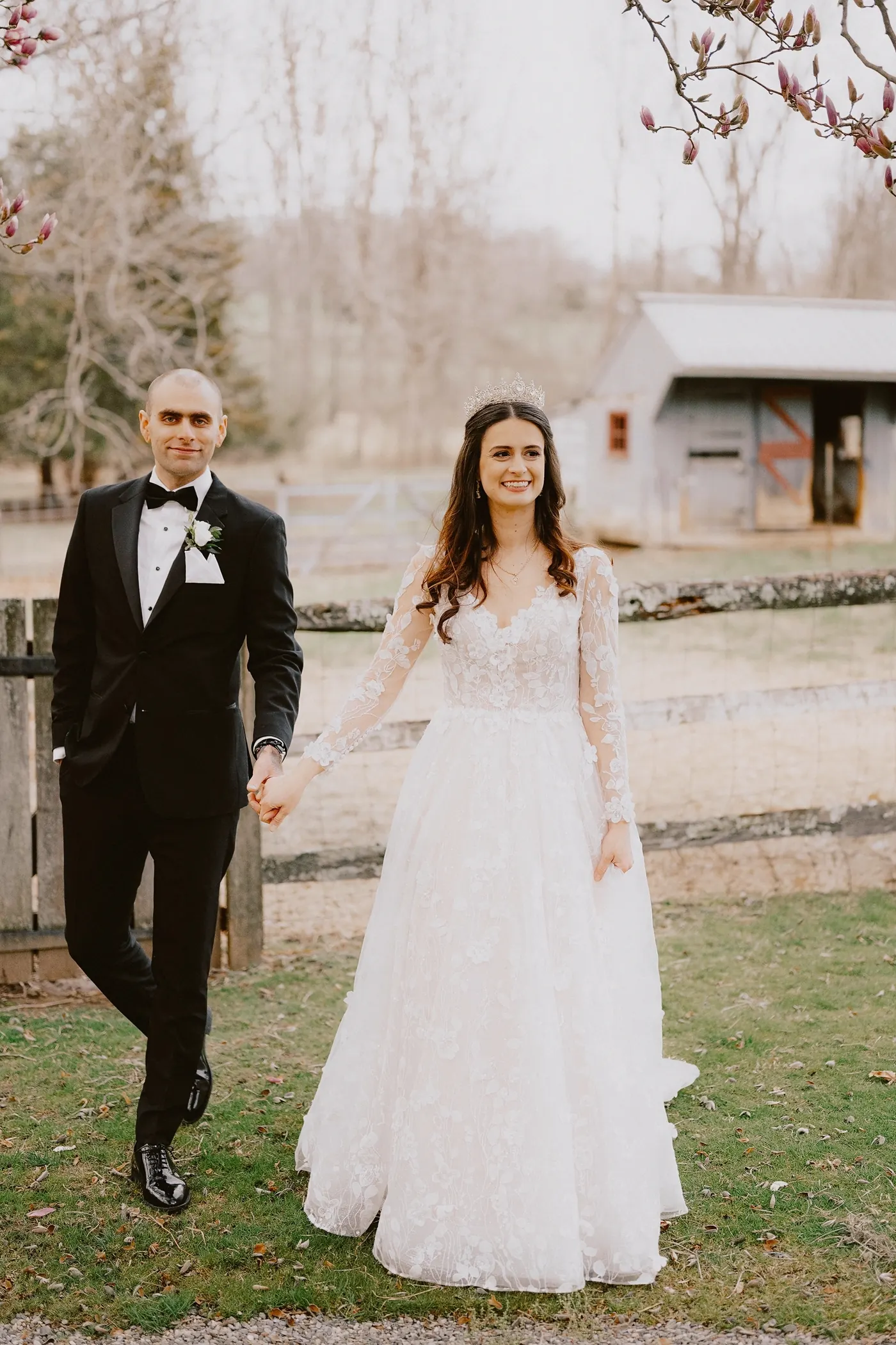 Steve and Maria walking hand in hand across the lawn